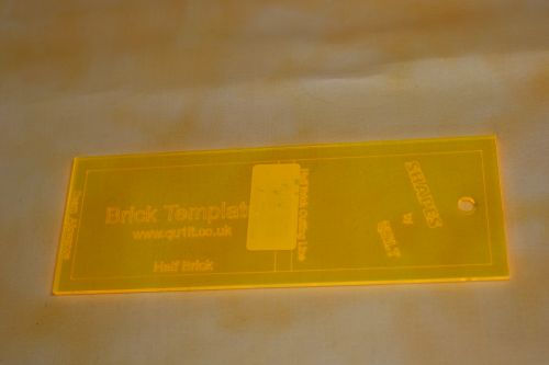 A BRICK SHAPED ACRYLIC TEMPLATE FOR THE BRICK WALL PATTERN